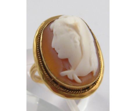 A yellow metal (tests 9 carat gold) shell cameo ring, size K, 4 gms.