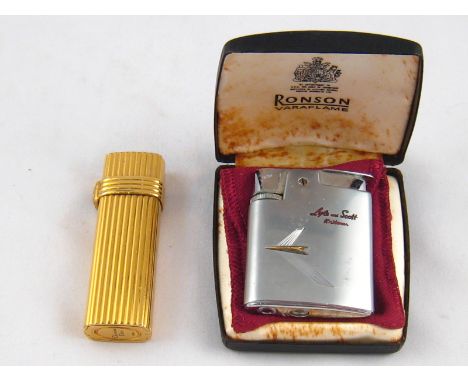 A gold plated Christian Dior gas lighter and a Ronson Varaflame lighter advertising “Y Fronts” in presentation case. 