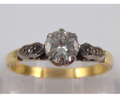 A yellow metal (tests 18 carat gold) diamond solitaire ring, the round brilliant cut diamond of good colour and clarity measu