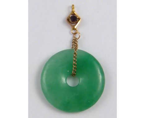 A jade disc pendant, approx 23mm diameter.