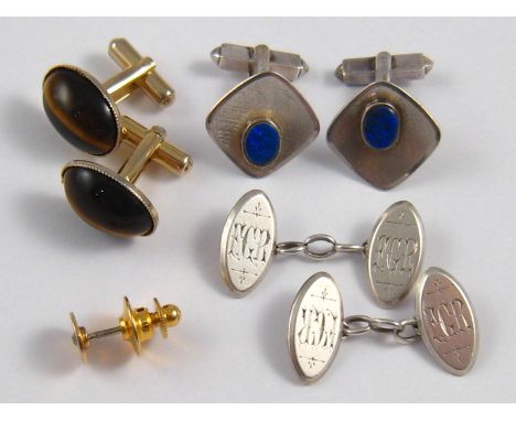 A mixed lot comprising a pair of silver cufflinks, a pair of cufflinks marked sterling, a pair of tiger's eye cufflinks and a