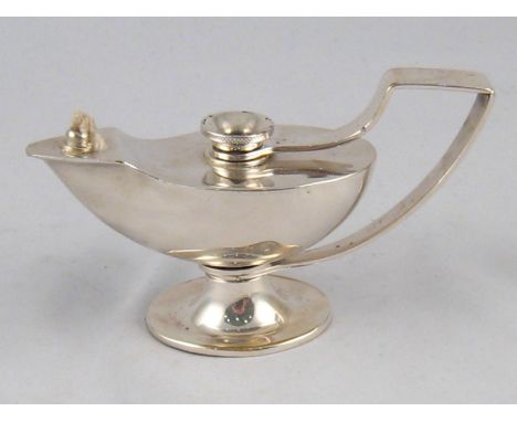 A white metal Roman lamp table cigar lighter, unmarked, tests silver. 