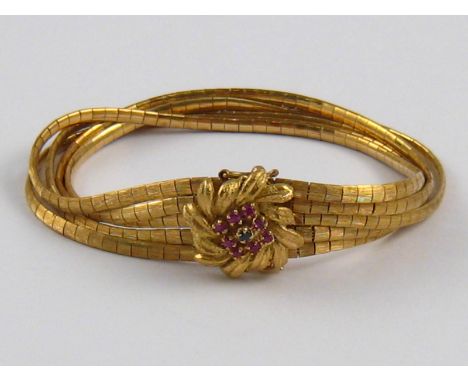 A yellow metal (tests 18 carat gold) multi strand bracelet, with ruby and sapphire set clasp, approx 19cm long, 39.2 gms.
