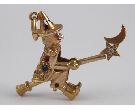 A yellow metal (tests 9 carat gold) charm, with moving arms and broom stick, approx 4cm, 4.1 gms.
