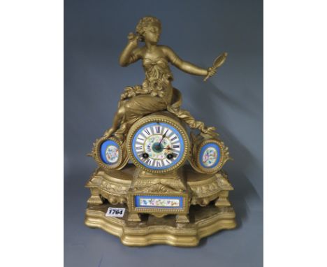 A 19th century ormolu mantel clock on base with porcelain panels surmounted by a figure of a girl, the dial signed J W BENSON