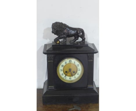 A 19th century French black marble mantel clock with lion support to top, Arabic numerals on stepped base 
Condition report: 