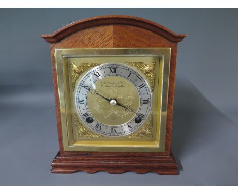 An Elliot mantel clock - striking, in walnut case, Roman numerals to dial, early 20th century brass face and bell