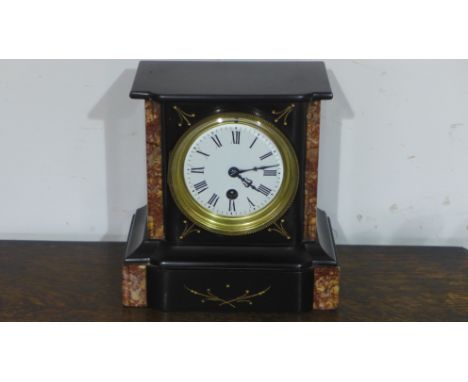 A black slate mantle clock with key and pendulum