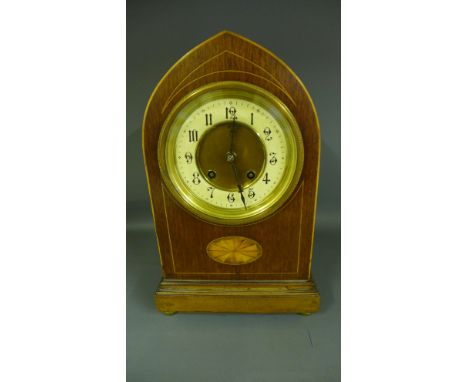 An Edwardian walnut inlaid mantel clock having brass and cream dial with separate chapter ring and cathedral hands, Roman num