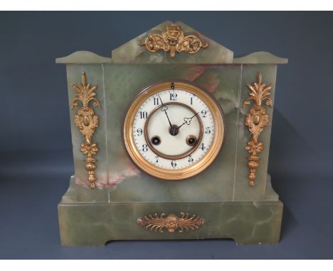 A green marble mantel clock, Arabic numerals to dial, flanked by foliate brass columns 