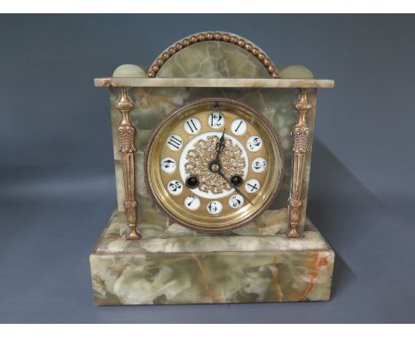 A green marble mantel clock, Arabic numerals to dial flanked by brass columns