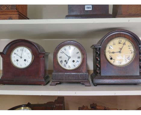 Two oak mantel clocks and a mahogany mantel clock 
Condition report: Two missing pendulums 