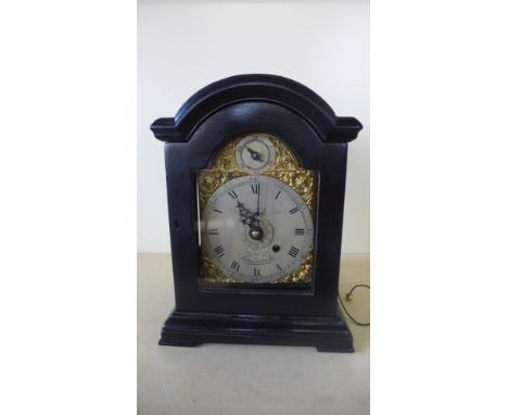 A good quality 18th century ebonised bracket clock of small proportions with a 4" arched dial having calendar and alarm secon