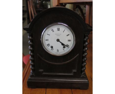 An oak barleytwist mantel clock - The Renown - the dial signed Bravingtons London - Height 33cm