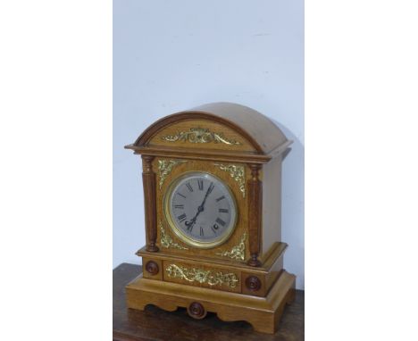 A 19th century light oak cased mantel clock with ormolu mounts, circular dial with Roman numerals by Winterhalder & Hoffhier 