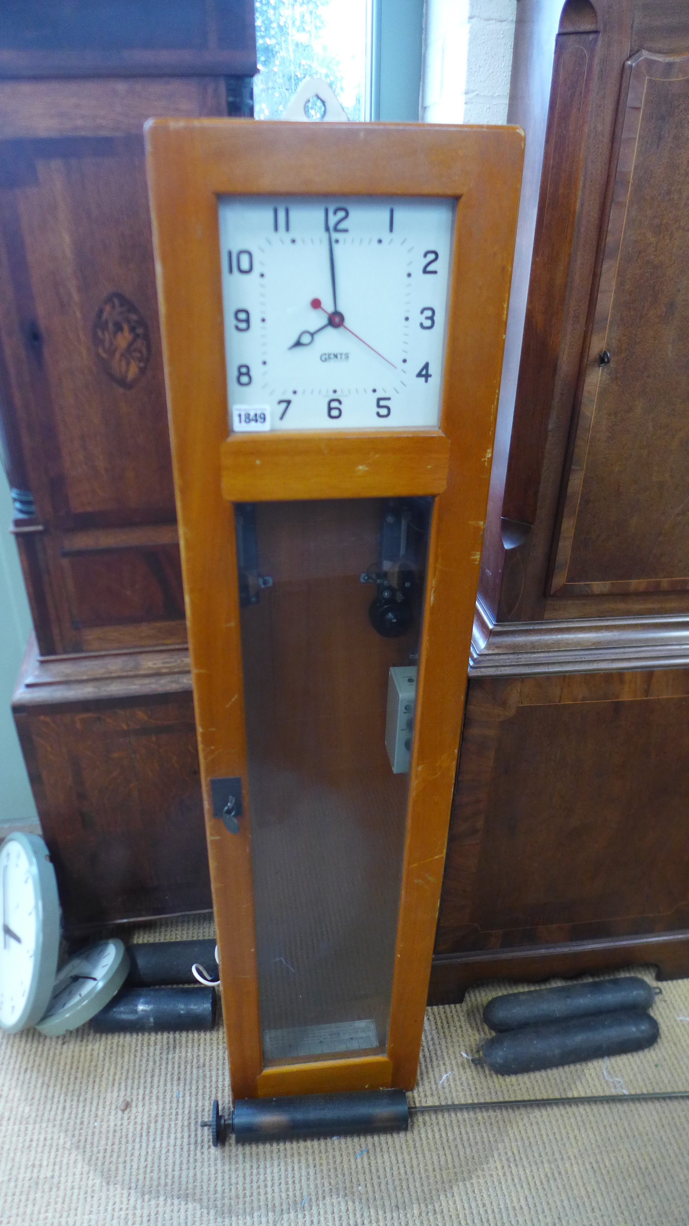 Gents of Leicester Electric Master clock with sweep seconds within a light oak glazed case Heig