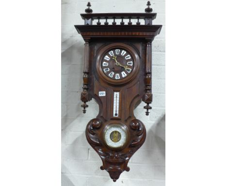 An early 20th century walnut case wall clock applied Roman lozenges, polished brass hands over twin scale thermometer and ins