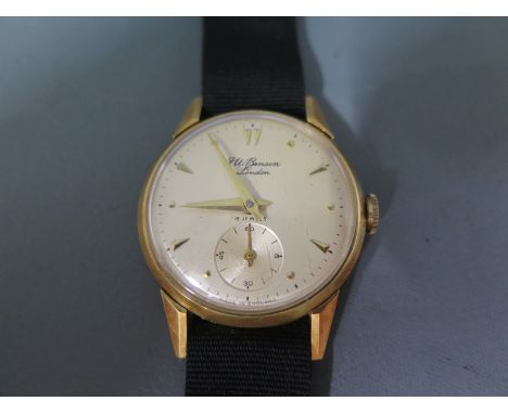 A 1950's 18ct gold J.W. Benson Gentleman's wristwatch having a cream dial with applied triangular and dot markers with second