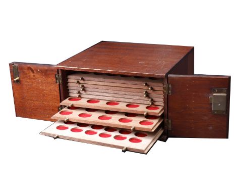 A wooden coin cabinet, 30 x 29 x 17cm, containing 10 trays (4 missing) single-pierced to house a total of 303 coins of variou