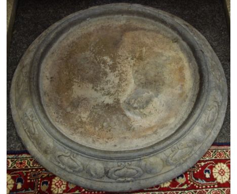 An Arts and Crafts lead bird bath basin, circular in form with styalized tulip border. 65cm diameter.