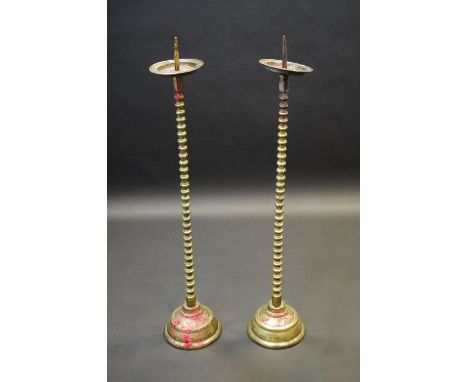 A pair of 19th century brass floor standing pricket candlesticks, of Charles II design, dished drip pans, bobbin stems, domed