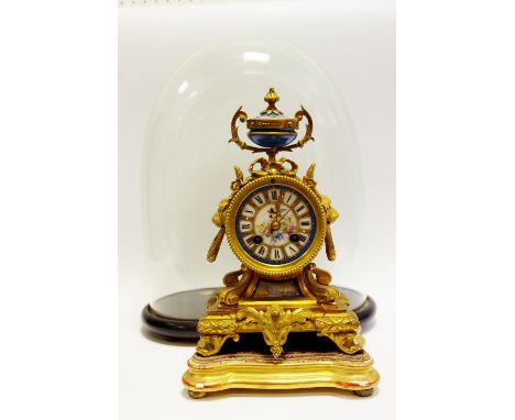 A 19th century French gilt metal mantel clock, with porcelain circular dial with Roman numerals, on a blue celeste ground, lo