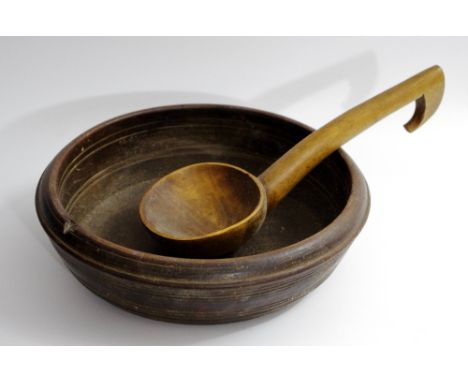 A 19th century turned sycamore bowl, 27cm diam;  a ladle (2)