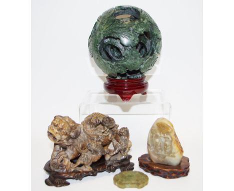 A Chinese carved jade puzzle ball,  carved with six layers, plinth base,  16cm high, boxed; a carved Chinese jade pendent, sc