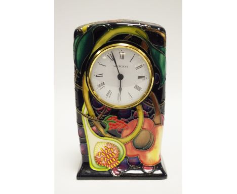 A contemporary Moorcroft Pomegranate mantel clock, tube lined with fruit and foliage on a cobalt blue ground,  15cm high, imp