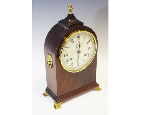 A Franz Hermle Comitti of London arched top mahogany mantel clock, with Roman numerals, twin winding holes,  striking on a be