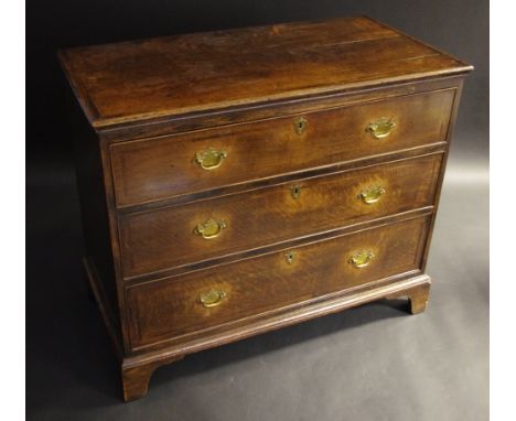 A George III oak chest,  of three long cockbeaded drawers, bracket feet, 85cm high, 99cm long,  c.1800