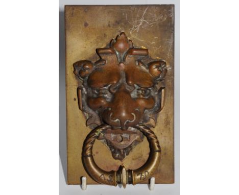 A bronzed door knocker, as a lion's head, rectangular back plate, 14cm x 8.5cm