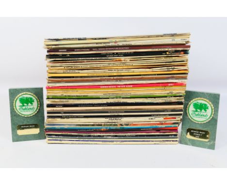 A collection of 12" vinyl records to include The Beatles, ABBA, Paul Simon, Motown, Michael Jackson and other. [W]