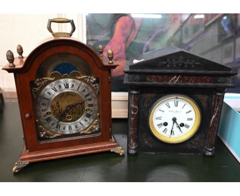 A walnut and brass mounted mantel clock with the brass moon-phase dial with silvered chapter ring and German triple-train eig
