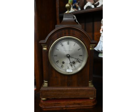 A walnut and brass mounted bracket clock with silvered dial inscribed 'Hampton &amp; Sons Ltd, Pall Mall East', with twin-tra