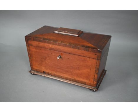 A Regency mahogany sarcophagus form tea caddy, the interior with twin lidded boxes flanking a centre well, on bun feet, 33 cm