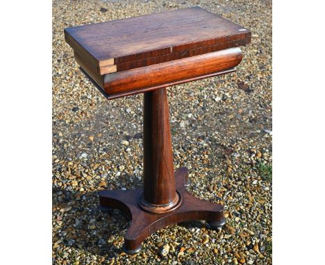 A Regency rosewood games table, the rectangular fold over top revealing a chequers board and backgammon board over a storage 