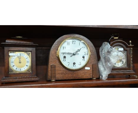 A walnut and brass mounted mantel clock with moon-phase dial and twin train movement, 24 cm high c/w key to/w a 1920's arched