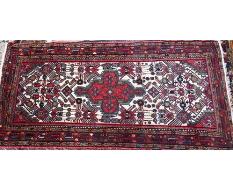 A contemporary rug/runner, the geometric design on red and cream ground, 198 cm x 94 cm 