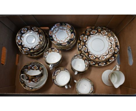 An early 20th century Royal Albert Imari part tea service comprising two 23 cm cake plates, nine teacups, eleven saucers, ten