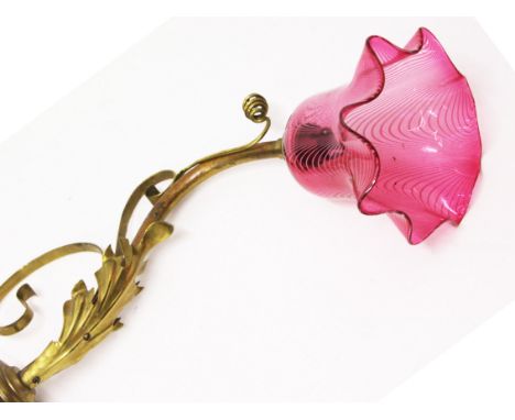 An Arts &amp; Crafts brass wall light with trailed glass shade in the manner of Benson. L38cm. Condition - generally very goo