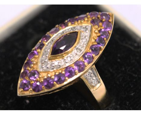 A 10K gold diamond and amethyst ring. Wt. 4.3g Size M