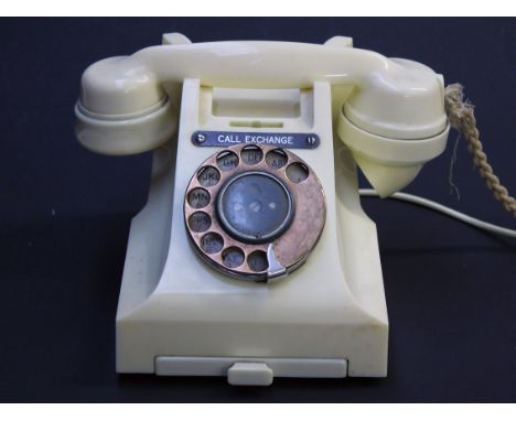 A cream plastic vintage telephone, the base numbered L11579 A2 312L H57/3A and the handset 164 56. Condition - appears good, 