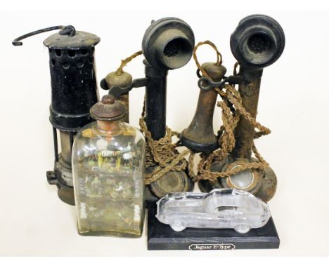 A mixed lot comprising two telephones, a miner's lamp, a miniature mine in a glass bottle and a Hofbauer model car. Condition