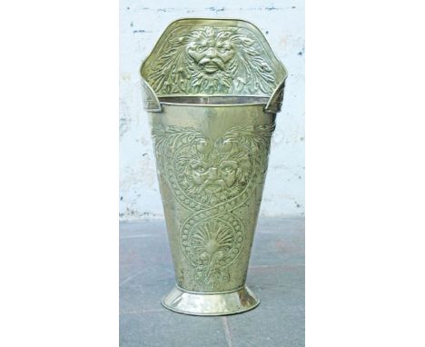 An Arts and Crafts brass stick stand with embossed decoration of The Green Man. H81cm.