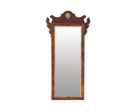 GEORGE II PERIOD WALNUT AND PARCEL GILT FRETWORK FRAMED PIER MIRROR CIRCA 1750The rectangular plate within a moulded parcel g