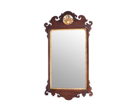 GEORGE II PERIOD WALNUT AND PARCEL GILT FRETWORK FRAMED PIER MIRROR CIRCA 1750The rectangular plate with serpentine corners t