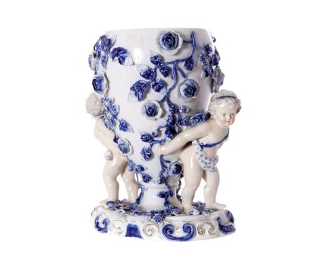 NINETEENTH-CENTURY SITZENDORF PORCELAIN VASEheld by two cherubs encrusted with flowers24 cm. high; 23 cm. wide; 12 cm. deep