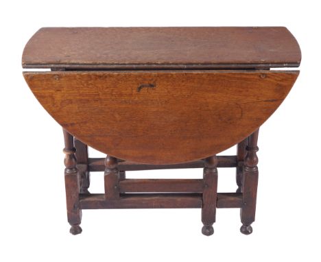 EIGHTEENTH-CENTURY OAK GATE LEG TABLEthe rectangular shaped top with rounded ends and D-shaped drop leaves raised on turned a