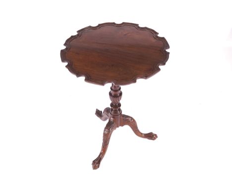 EDWARDIAN PERIOD MAHOGANY SNAP TOP WINE TABLEthe circular serpentine shaped top with a pie crust border raised on a turned st